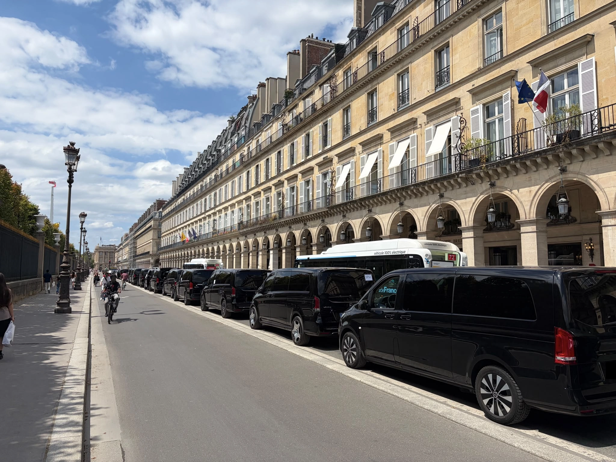 Cortège de vans Mercedes Classe V noirs EDEN CAB stationnés en file indienne le long de la rue de Rivoli à Paris pour une mission diplomatique.