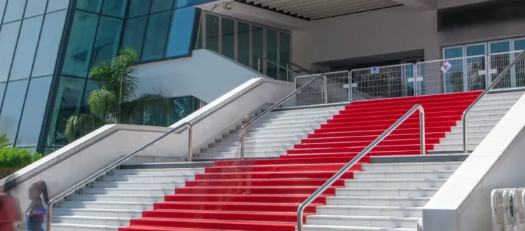 Façade du Palais des Festivals de Cannes avec ses 24 marches recouvertes du tapis rouge emblématique.